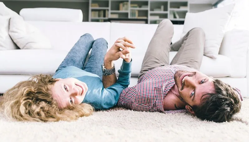 Couple relaxing on a freshly cleaned carpet