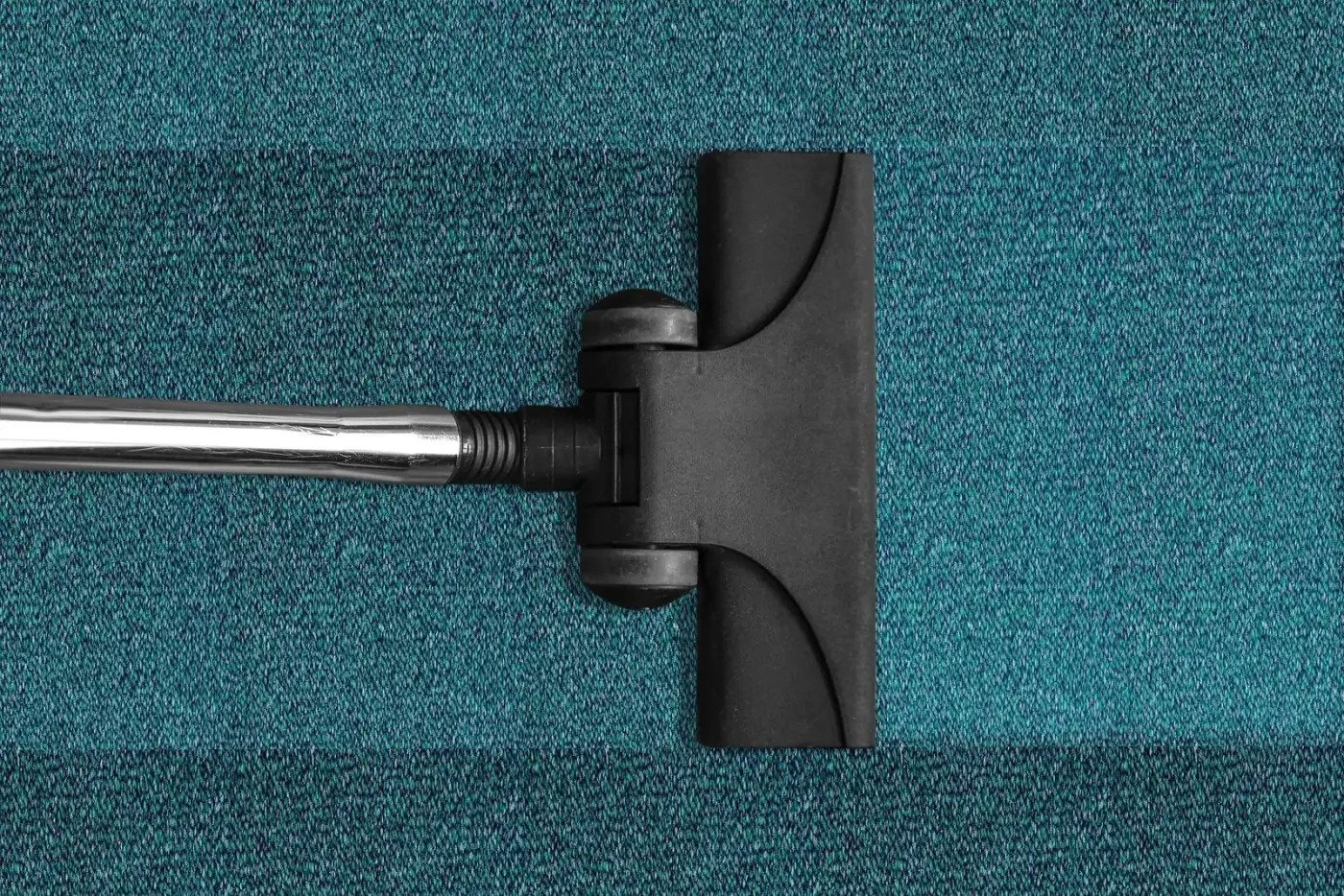 Vacuuming an area rug as part of odor removal service in Brigantine